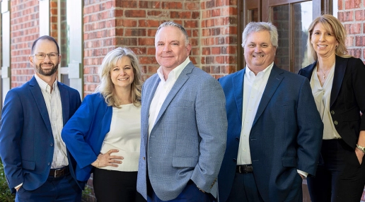 A group of Summit employees with Hughes Insurance President, Bret Hughes.