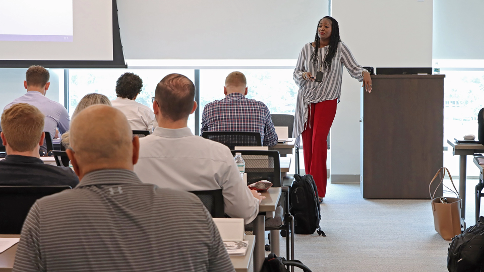 A Summit employee gives a presentation to a group of agents.
