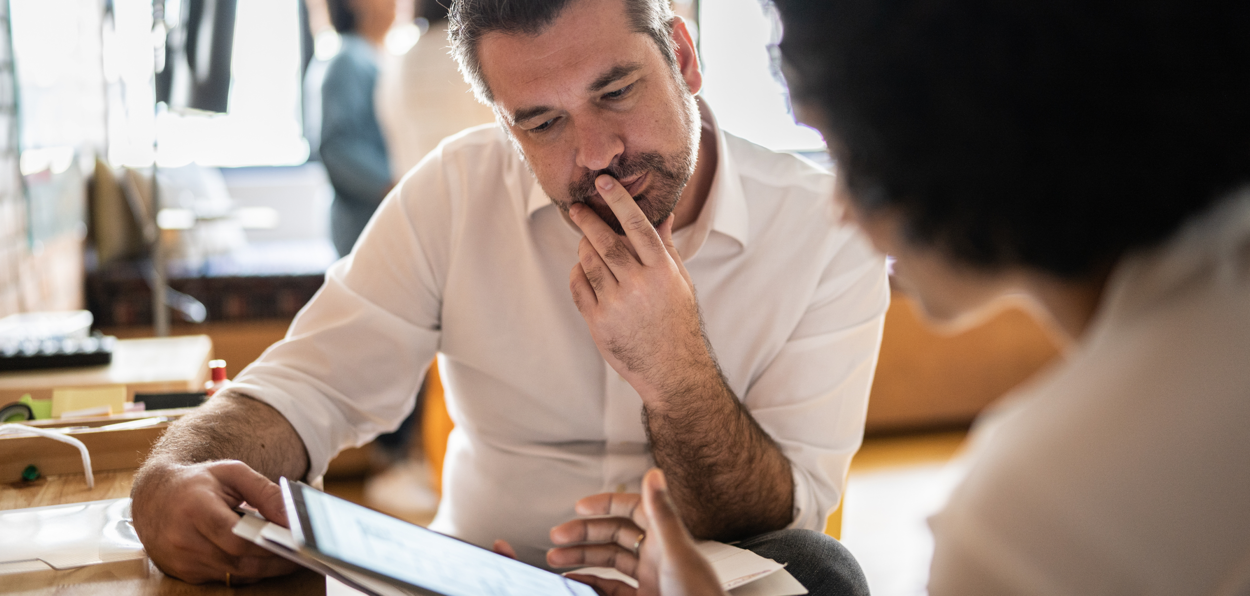 A man reviewing a document at his desk.